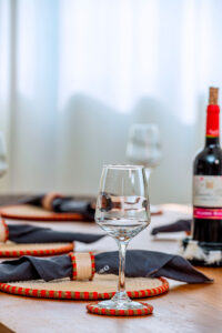 Handcrafted sisal coasters by Irebe Basket Collection arranged on a dining table to elevate a luxury dining experience