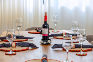 Intentional luxury dining table setup featuring handcrafted sisal placemats, coasters, and napkin rings by Irebe Basket Collection.