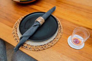 Handcrafted napkin ring holders by Irebe Basket Collection styled on a luxury dining table.