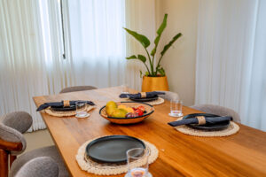 Luxury dining table set with handcrafted sisal placemats, coasters, and napkin rings by Irebe Basket Collection